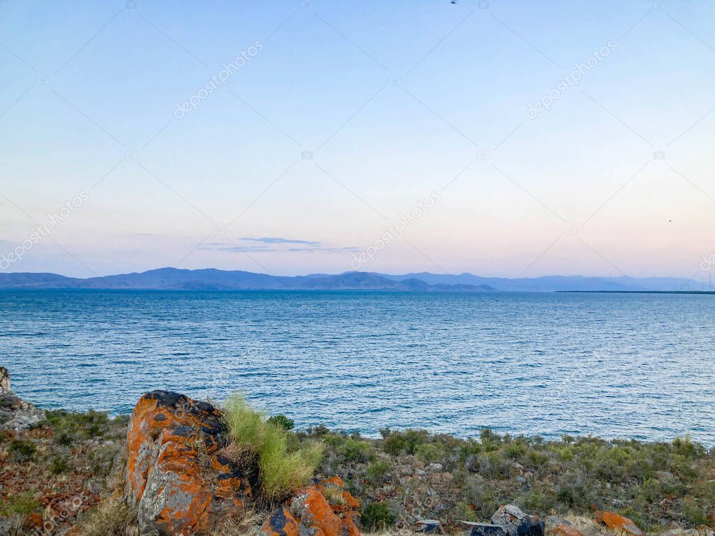 Beautiful view of Sevan lake with turquoise water and green hills, Sevan, Armenia