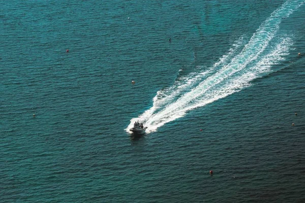 aerial view of a zodiac motorboat sailing in the turquoise sea
