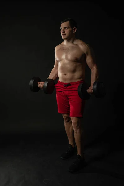 Spor salonundaki adam kırmızı külotlu halterleri ütülüyor. Erkek, erkek, erkek, erkek, erkek, erkek, başarılı, siyah vücutçu.