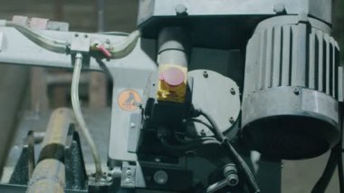 Ağır endüstri, elektrikli testereli bir makine metal çubukları daha fazla parça üretmek için kesiyor.