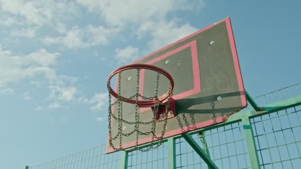 Facet sportowiec trenuje z koszykówki na placu zabaw, rzuca piłkę na ring 4k — Wideo stockowe