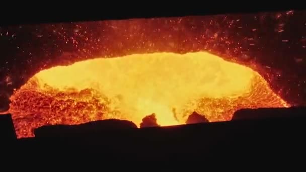 Corriente de metal fundido vertida de un cucharón a otro en fundición. Metal líquido en el horno. Proceso de producción de metal líquido. Moldeo de metal fundido en planta industrial. Movimiento lento — Vídeo de stock