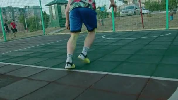 Kryvyi Rih Ukraine - 01.05.2021 guy athlete training with a basketball on the playground slow mo 4k 100fps — Stock Video