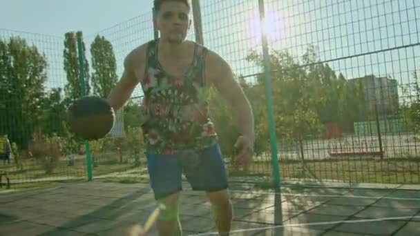 Kryvyi Rih Ukraine - 01.05.2021 guy athlete training with a basketball on the playground slow mo 4k 100fps — Stock Video