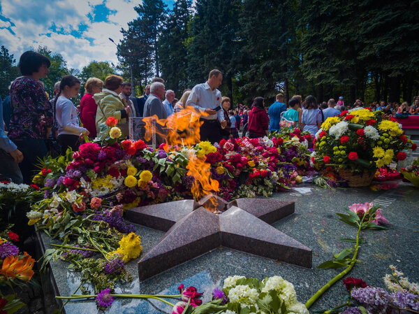 Kryvyi Rih, Ukraine - 05.09.2021 : Unidentified veterans lay flowers at Victory Monument during the celebration of Victory Day on May 9,