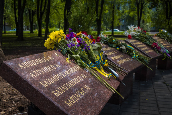 Krivoy Rog, Ukraine - may 18, 2020: A man with flowers near the memorial to fallen soldiers - defenders of Ukraine while honoring the memory of those killed in the battles for Debaltseve.