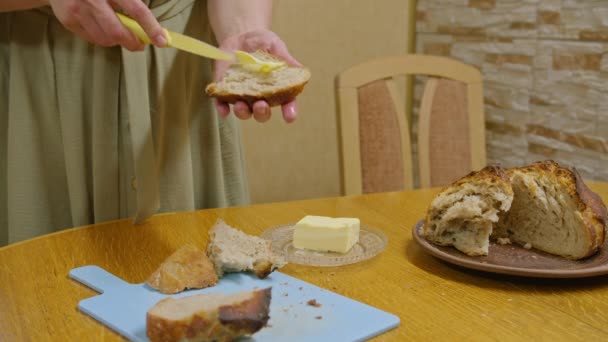 市販の映像ナイフでパンを切り、バターでサンドイッチを広げ、蜂蜜を注ぎ、踊り、サンドイッチを食べ、カメラで笑顔。Prores422 — ストック動画