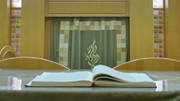 Kryvyi Rih, Ukraine - 08.03.2021 Tora in der Synagoge. die Bedeutung der Religion für die Juden. Das Buch steht im Vordergrund, im Hintergrund das Bild der Symbolik. — Stockvideo