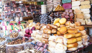 Assorted smoked bacon and colorful cheeses displayed on traditional Ukrainian farm market. Natural homemade organic food products from local farmers.