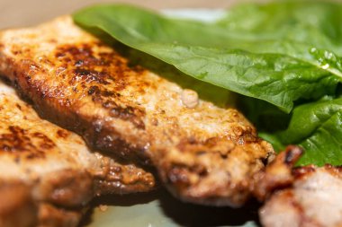 Fried meat with green lettuce leaf, homemade food concept and healthy meal idea