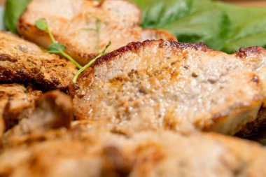 Fried meat with green lettuce leaf, homemade food concept and healthy meal idea