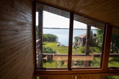 Dusty glass ceiling window in wooden interior house illuminated by sunlight concept of home cleaning maintenance and hygiene