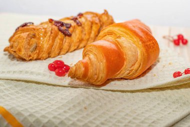 Çörekli taze hamur işleri ve waffle mutfak havlusu arka planında örülmüş tatlı çörek.