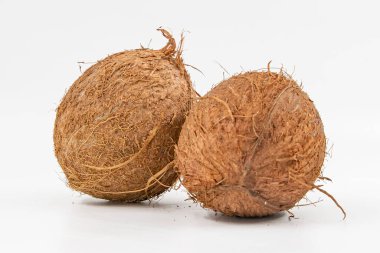 Kaba kahverengi kabuklu iki hindistan cevizi temiz beyaz arka planda izole edilmiş.