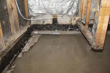 Banyo tadilatı sırasında temiz beton döşeme görünür tesisat ve ahşap yapı ile döşenmiş.