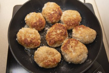 Çiğ ekmekli et pirzolası tavada kızartılıyor.