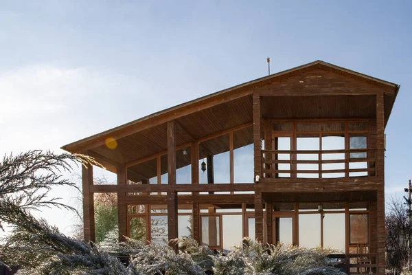 Kışın bahçesinde geniş pencereleri olan modern ahşap ev.