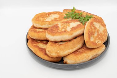 Beyaz arka planda izole edilmiş tabağa istiflenmiş ev yapımı köfteler.