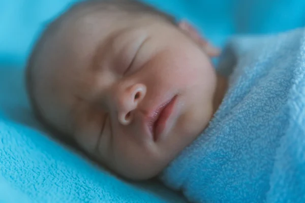 Newborn baby Asia  while sleeping covered with blue cloth — Stock Photo, Image