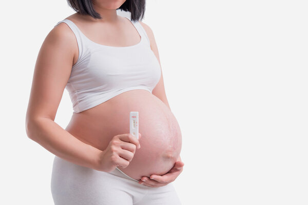 pregnant women hold the pregnancy tests White background