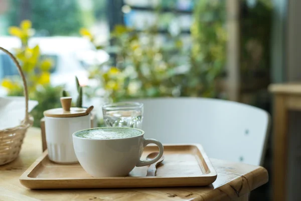 Sıcak yeşil çay bir coffeshop ahşap bir masa ayarlamak