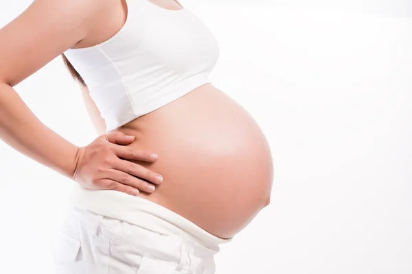 Pregnant woman holding ultrasound scan on her tummy — Stock Photo, Image