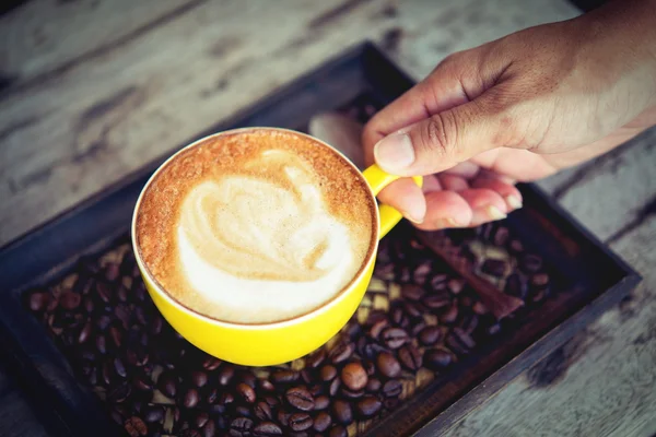 Woman holding coffee mocha hot  on wooden table — 图库照片