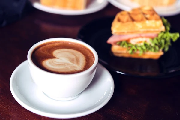 Coffee mocha hot on wooden table on brown background — Stock Photo, Image