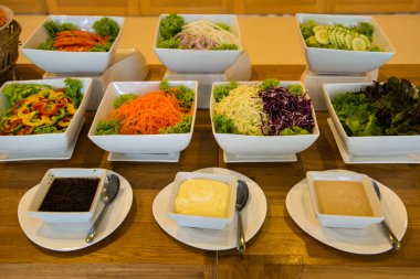 Salad bar with a variety of vegetables served buffet.
