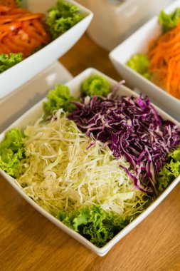 Salad bar with a variety of vegetables served buffet.