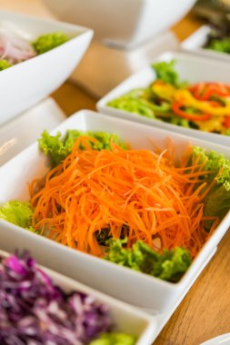Salad bar with a variety of vegetables served buffet.