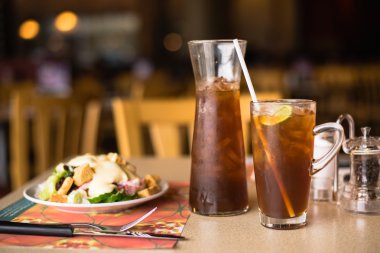 Lemon tea cold, put on a wooden table in a restaurant.