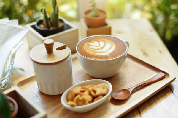 Arte del latte caldo con cactus in caffetteria sul tavolo di legno — Foto Stock