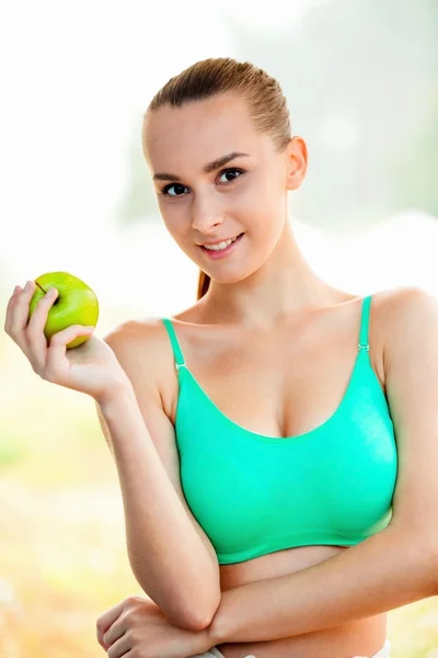 La chica del deporte con manzana Fotos De Stock Sin Royalties Gratis