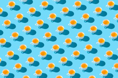 Colorful pattern with teacups on pastel blue background. Minimal creative retro concept idea.