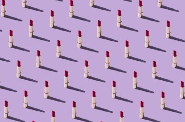 Colorful pattern with red lipstick against pastel purple background. Creative minimal retro concept.