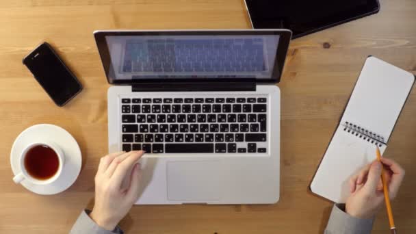 Usando laptop na área de trabalho — Vídeo de Stock