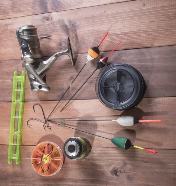 Coil, spools of fishing line, floats and a box of hooks — Stock Photo, Image