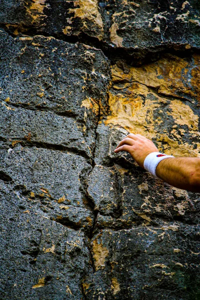 climbing. hand of climber grabs the rock. vertical format