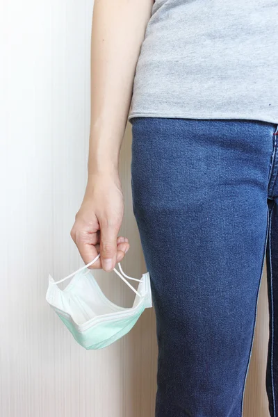 dişinin el tıbbi maskesi tutarak