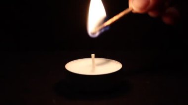 koyu arka plan üzerinde yanan mum.