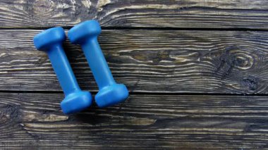 Ahşap arka planda fitness için dambıllar
