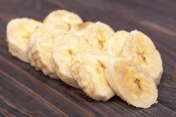 banana slices on black or rustic wooden background