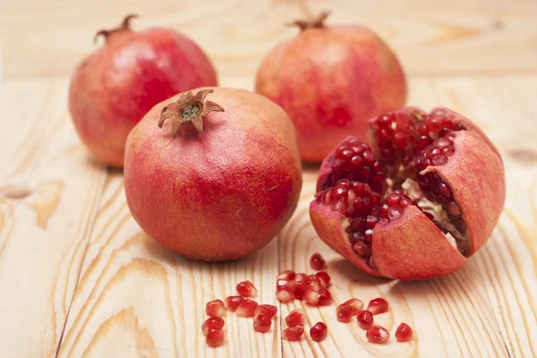 Pomegranate on wooden background — Stock Photo, Image