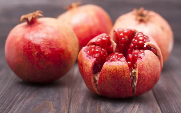 Pomegranate on wooden background — Stock Photo, Image