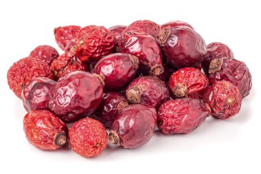 Yığın üzerinde beyaz izole kurutulmuş kuşburnu çilek.