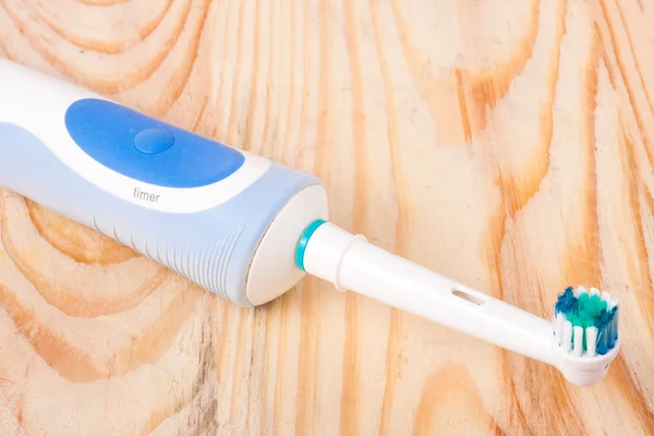 Electric Toothbrush on a light wooden background — Stock Photo, Image