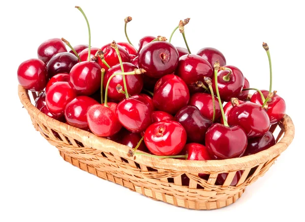 Cerezas en una canasta de mimbre aislada sobre fondo blanco — Foto de Stock