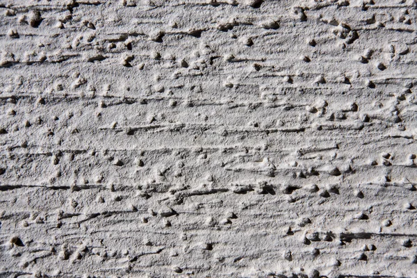 Grey wall with decorative plaster as a background — Stock Photo, Image