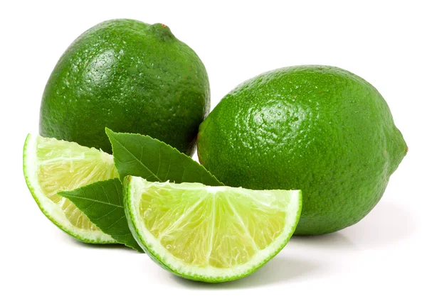 Two limes with slices and leaf isolated on white background — Stock Photo, Image